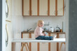 © somemeans - Toddler sits on kitchen table and waits for mom. Home breakfast