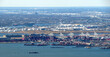 © otmman - A view of Port Liberty and a full container ship in the New York Harbor in Bayonne New Jersey.