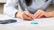 © BillionPhotos.com - Close-up of a Businesswoman Analyzing Financial Figures