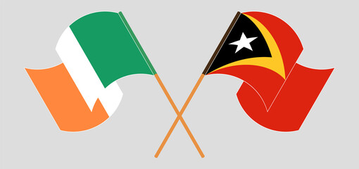 Crossed and waving flags of East Timor and Ireland