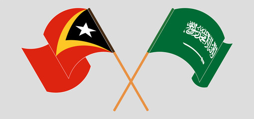 Crossed and waving flags of Kingdom of Saudi Arabia and East Timor