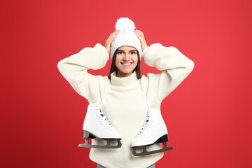 Sticker - Happy woman with ice skates on red background