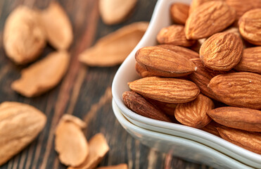 Wall Mural - Almonds almond kernels lie on a dark tree.