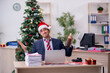 © Elnur - Young male employee celebrating new year in the office