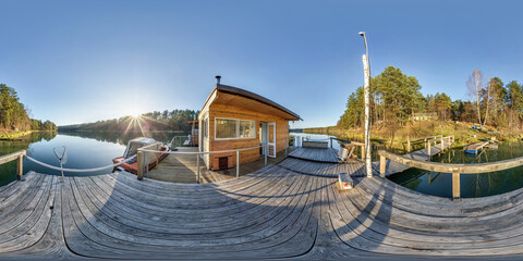 Wall Mural - full spherical hdri panorama 360 degrees angle view on wooden pier near landing stage house on water in forest in evening in equirectangular projection with zenith, ready VR AR content.