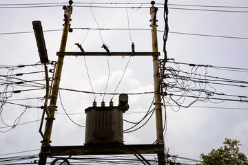 A high voltage power transformer with sky background, old and rusty transformer of old Dhaka.