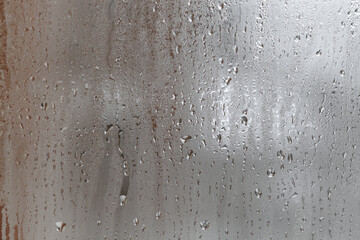 Close up for misted glass with droplets of water draining down. Dripping Condensation, Water Drops Background Rain drop Condensation Texture