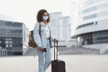 Young Woman Tourist Holding Passport And Ticket, Girl Wearing Protective Face Mask In A City, Business Travel During Pandemic, Corona Virus Protection, Healthy Lifestyle, People, Tourism Concept
