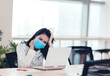 © Tom Wang - Stressed  and tired young  business woman wear face mask working on laptop