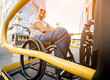 © romaset - A man in a wheelchair on a lift of a vehicle for people with disabilities