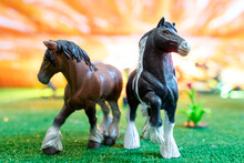 Plastic Figurines Of Wild Horses On Orange Background