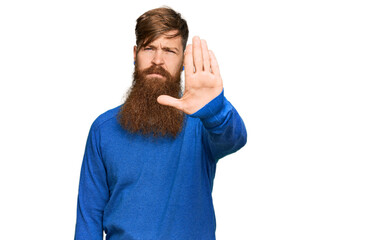 Canvas Print - Young irish redhead man wearing casual clothes doing stop sing with palm of the hand. warning expression with negative and serious gesture on the face.