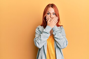 Sticker - Young beautiful redhead woman wearing casual sporty sweatshirt shocked covering mouth with hands for mistake. secret concept.