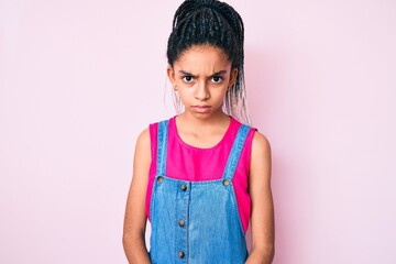 Poster - Young african american girl child with braids wearing casual clothes over pink background skeptic and nervous, frowning upset because of problem. negative person.