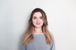 © Hazal - Portrait of young beautiful cute cheerful girl smiling looking at camera over white background.