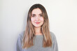 © Hazal - Portrait of young beautiful cute cheerful girl smiling looking at camera over white background.