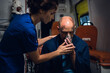 © Anna Kosolapova - Paramedic presses an oxygen mask to a man's face, who got into an accident.