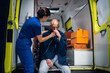 © Anna Kosolapova - A young nurse in a uniform gives an oxygen mask to an injured man in a blanket.