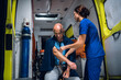© Anna Kosolapova - Pretty nurse applies a tourniquet to her patient's hand to take a blood test.