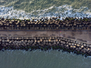 Wall Mural - aerial view of a jetty at the entrance of the harbour of Scheveningen