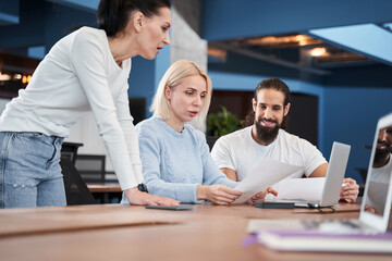 Canvas Print - People attentively looking at the documents