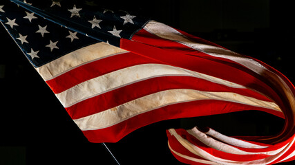 Wall Mural - Waving American Flag on Black Background. Lots of Copy Space.