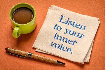 Wall Mural - listen to your inner voice - inspirational handwriting on a napkin with a cup of coffee, confidence, intuition and personal development concept