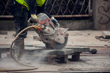 Cutting The Curb With With Cut-off Saw. Road Works
