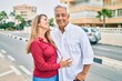 © Krakenimages.com - Middle age hispanic couple smiling happy and hugging walking at street.