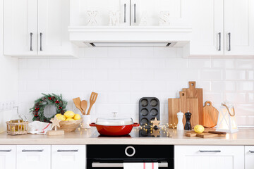 Christmas home kitchen interior with wooden worktop and kitchenware, holiday cooking background