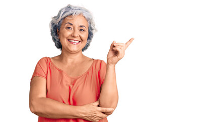 Poster - Senior woman with gray hair wearing orange tshirt smiling happy pointing with hand and finger to the side