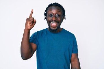 Canvas Print - Young african american man with braids wearing casual clothes pointing finger up with successful idea. exited and happy. number one.