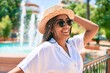 © Krakenimages.com - Young african american woman with braids wearing sunglasses and smiling happy outdoors on a sunny day of summer