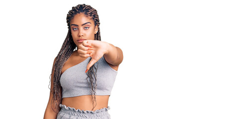 Sticker - Young african american woman with braids wearing sportswear looking unhappy and angry showing rejection and negative with thumbs down gesture. bad expression.