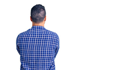 Wall Mural - Young hispanic man wearing casual clothes standing backwards looking away with crossed arms