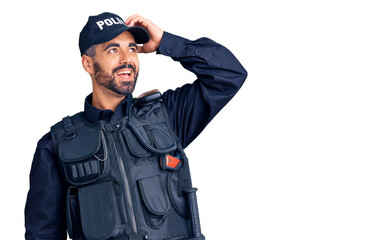 Poster - Young hispanic man wearing police uniform smiling confident touching hair with hand up gesture, posing attractive and fashionable