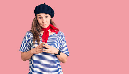 Sticker - Young beautiful blonde woman wearing french beret and striped t-shirt hands together and fingers crossed smiling relaxed and cheerful. success and optimistic