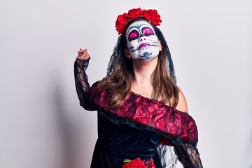 Sticker - Young woman wearing day of the dead costume over white stretching back, tired and relaxed, sleepy and yawning for early morning