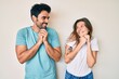 © Krakenimages.com - Beautiful young couple of boyfriend and girlfriend together laughing nervous and excited with hands on chin looking to the side