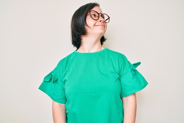 Sticker - Brunette woman with down syndrome wearing casual clothes and glasses looking to side, relax profile pose with natural face and confident smile.