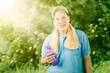 © Creativa Images - Elderly man holding a bottle of water at park