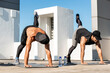 © Atstock Productions - Muscular sports men doing plank leg raise exercise in the open air on building rooftop