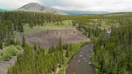 Sticker - Yellowstone river in the middle of the forest on a cloudy day