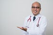 © Chanakon - Doctor in white coat, stethoscope pointing left hand to beside look into.camera with smile isolated on white background.