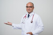 © Chanakon - Doctor in white coat, stethoscope pointing right hand to beside look into.camera isolated on white background.