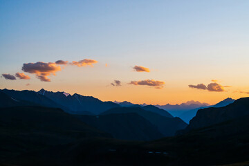 Wall Mural - colorful dawn landscape with beautiful mountains silhouettes and golden blue gradient sky with cloud