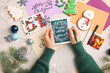 © Pixel-Shot - Woman writing greeting postcards for Christmas and New Year celebration at table
