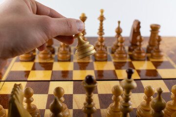 a man takes a step with a chess piece