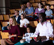 © JackF - caucasian mother, african father and their children sitting at comedy in auditorium