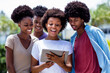 © Daniel Ernst - Happy african american young adults streaming movie with digital tablet